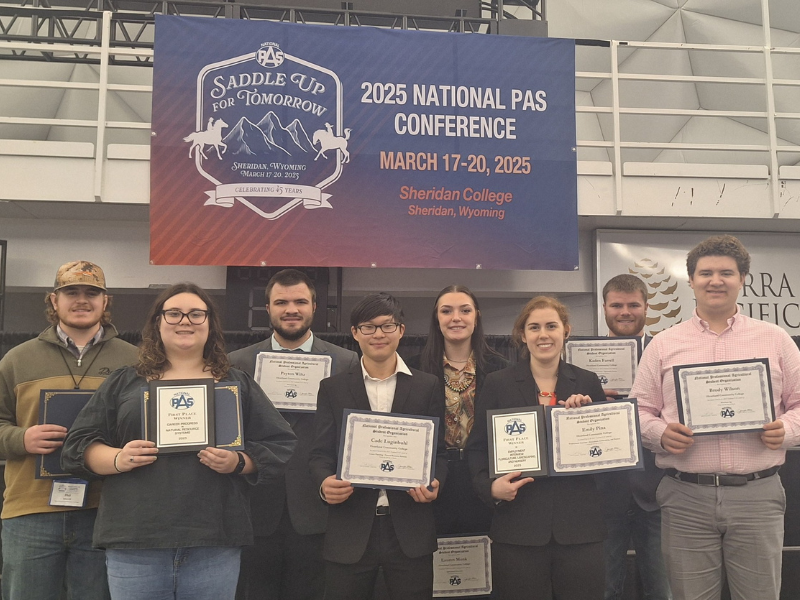 A photo of a group of students with award certificates