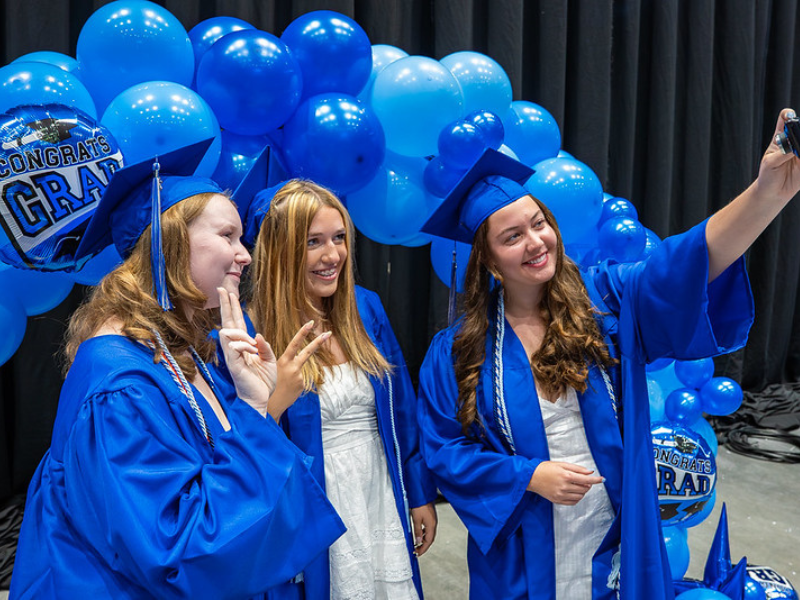 Students taking a selfie at commencement
