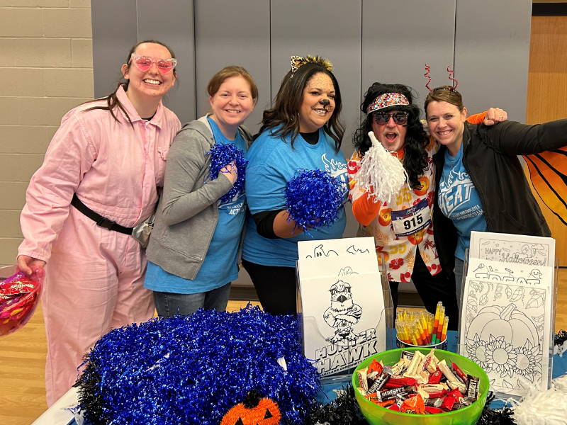 Picture of a group of people dressed in costume in a gym