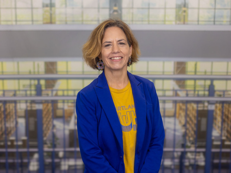 Photo of a woman in front of a backdrop