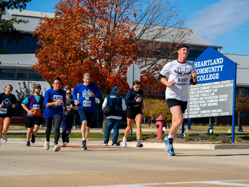 A of a group of people running a race on Heartland's campus