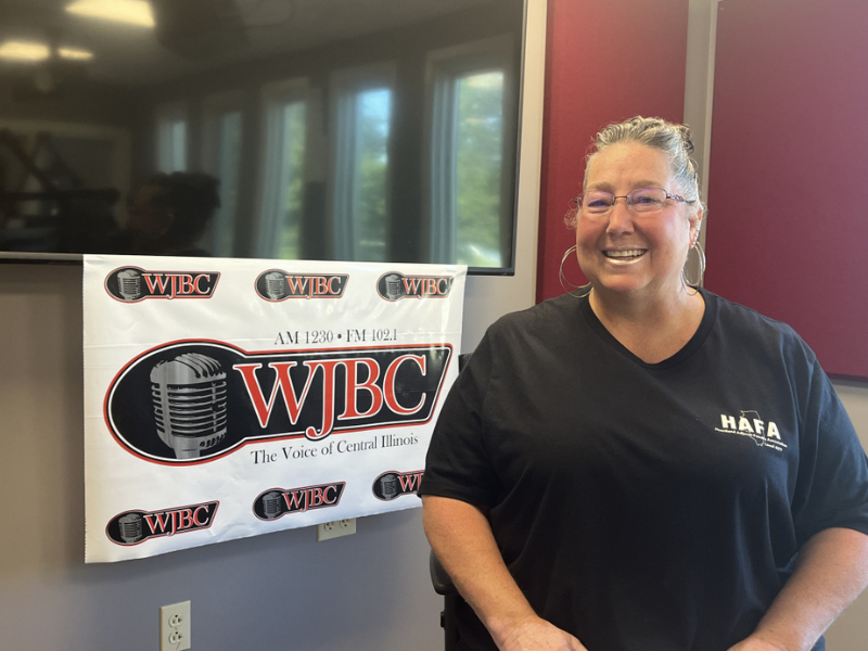 A picture Jean-Marie Taylor standing in front of a sign that says WJBC
