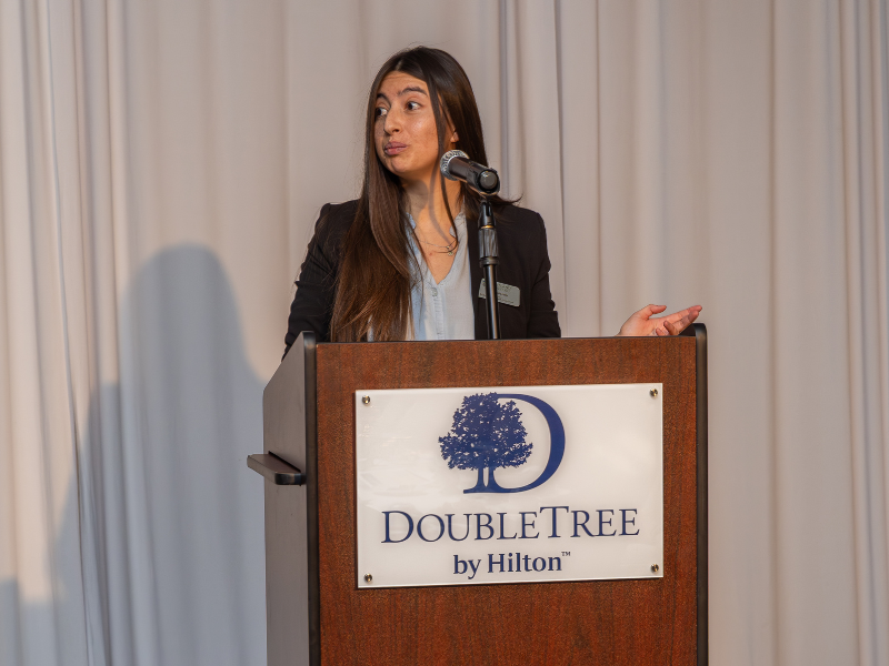 A picture of a woman speaking at a podium