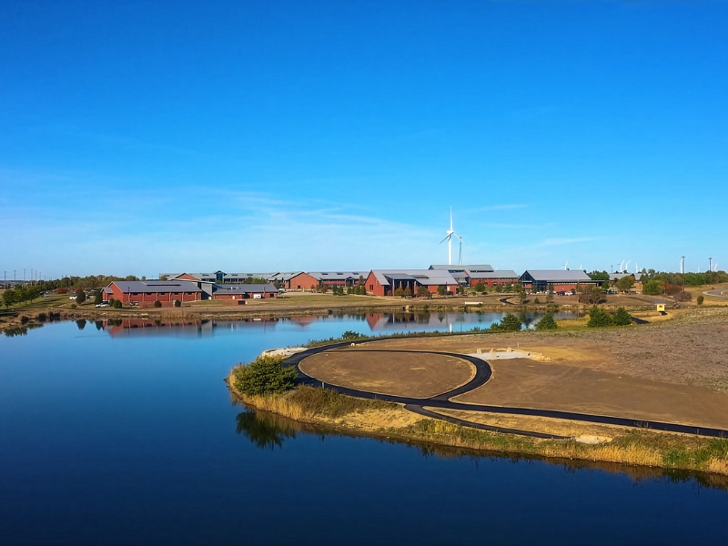 A drone photo of the campus with the new trail in the foreground