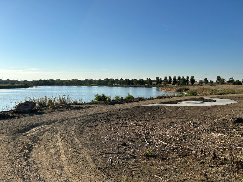 A picture of a pondside trail under construction