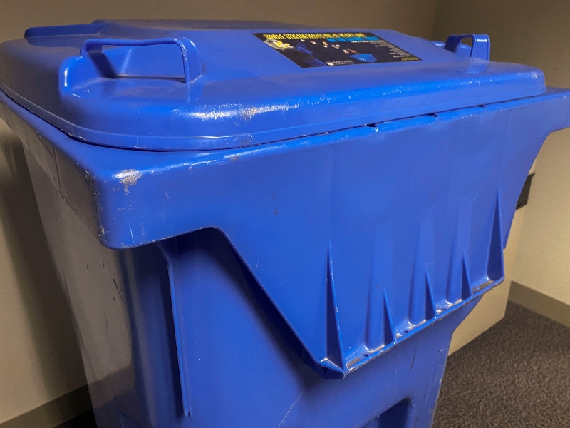 A picture of a blue recycling bin
